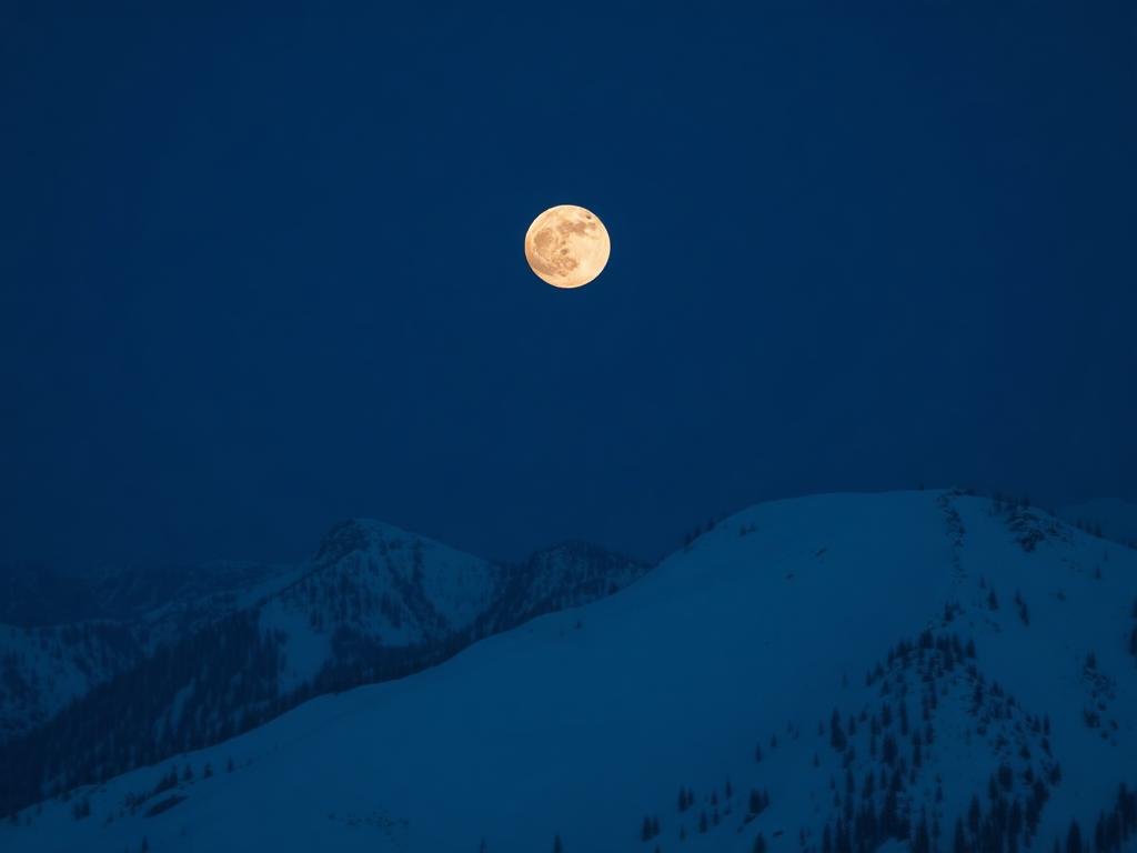 Full moon over a snowy ridge